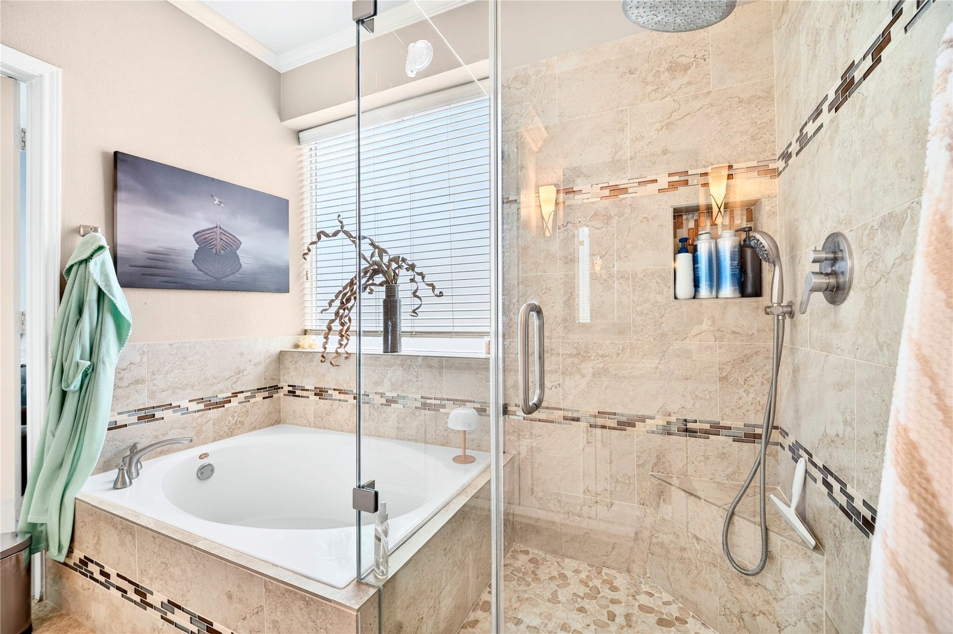 Beautiful tiled walk-in shower and soaking tub create a relaxing primary retreat.