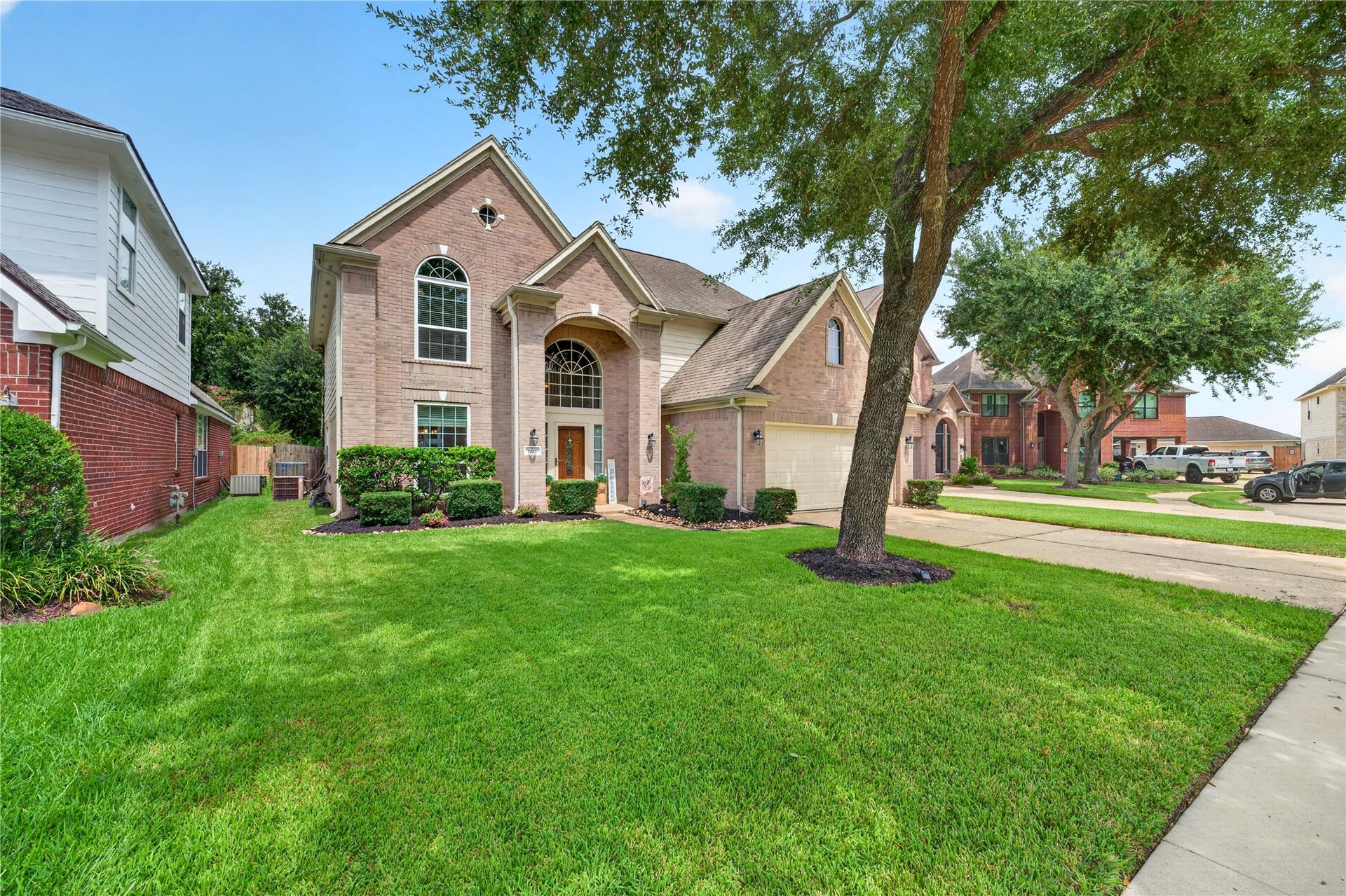 Beautiful two-story brick home with mature landscaping and great curb appeal.