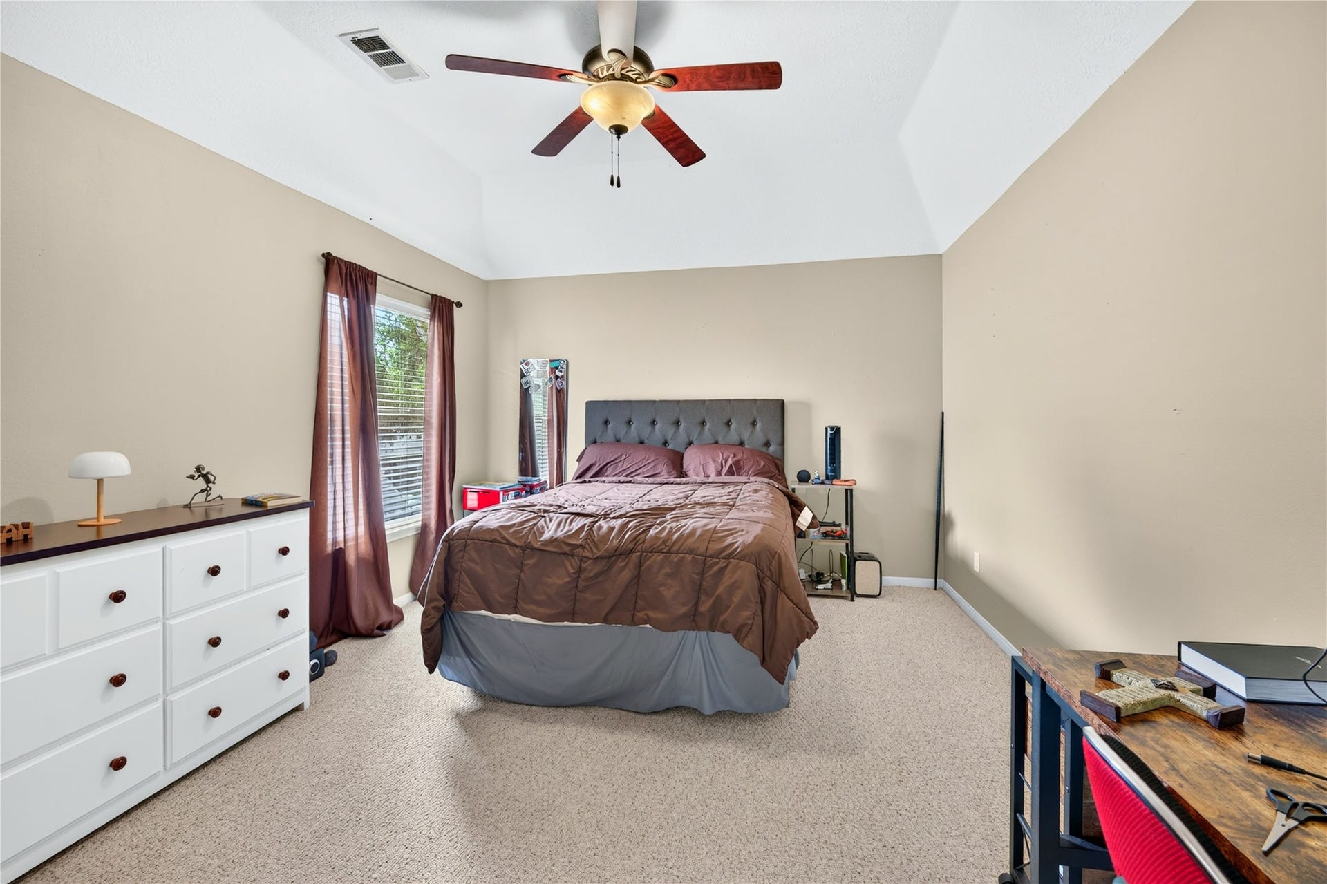 Spacious secondary bedroom with vaulted ceiling and plenty of natural light.