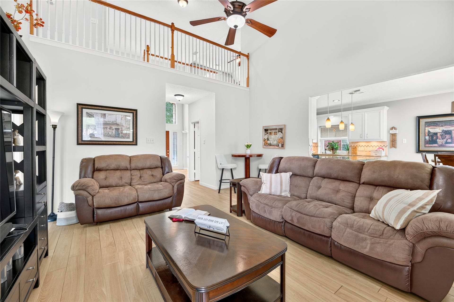 Open-concept living area with high ceilings and views into the kitchen.