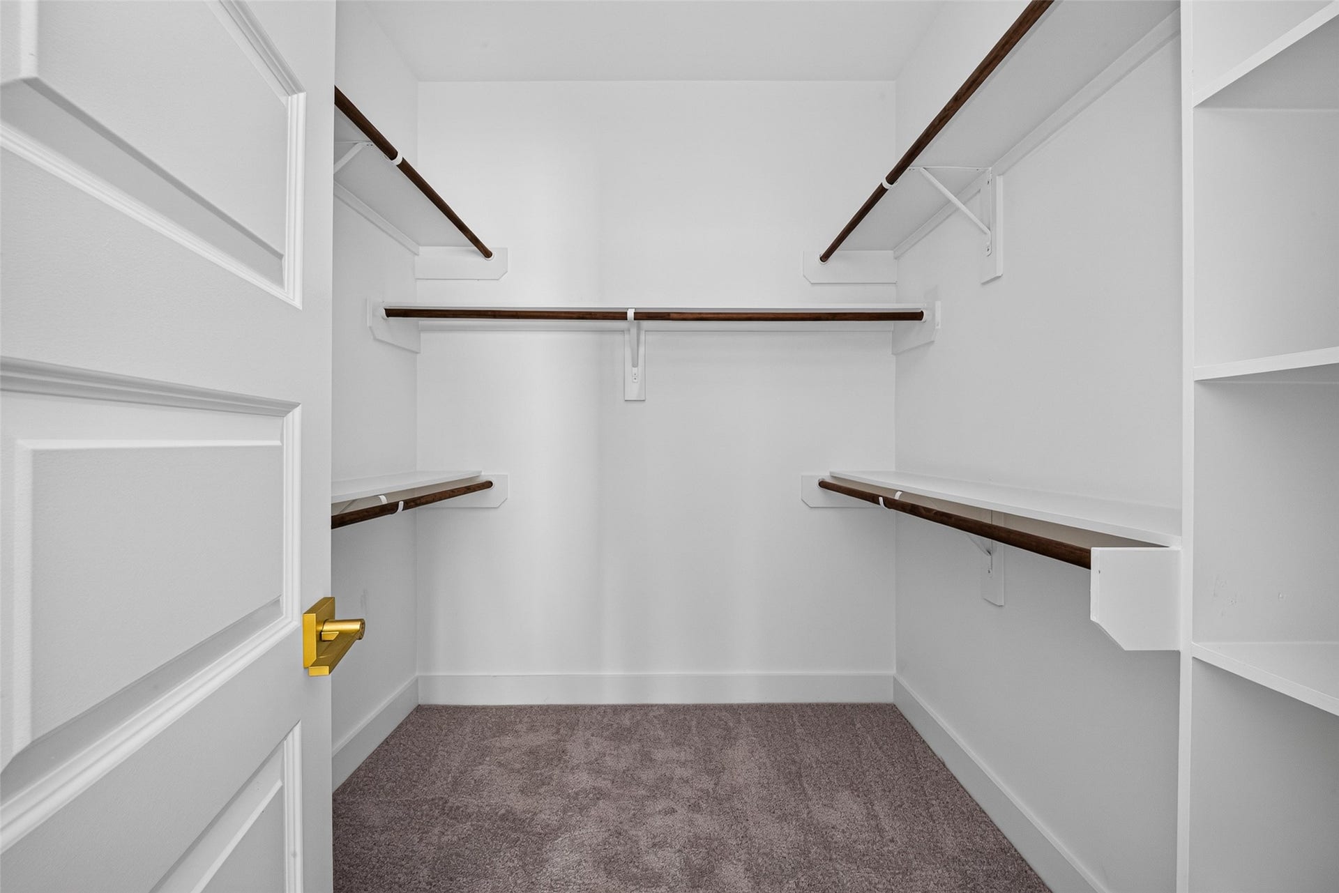9309 Caddo Road, #B, Houston, TX 77078 A massive walk-in closet with multi-tier hanging rods and built-in shelving, providing plenty of room for any wardrobe.