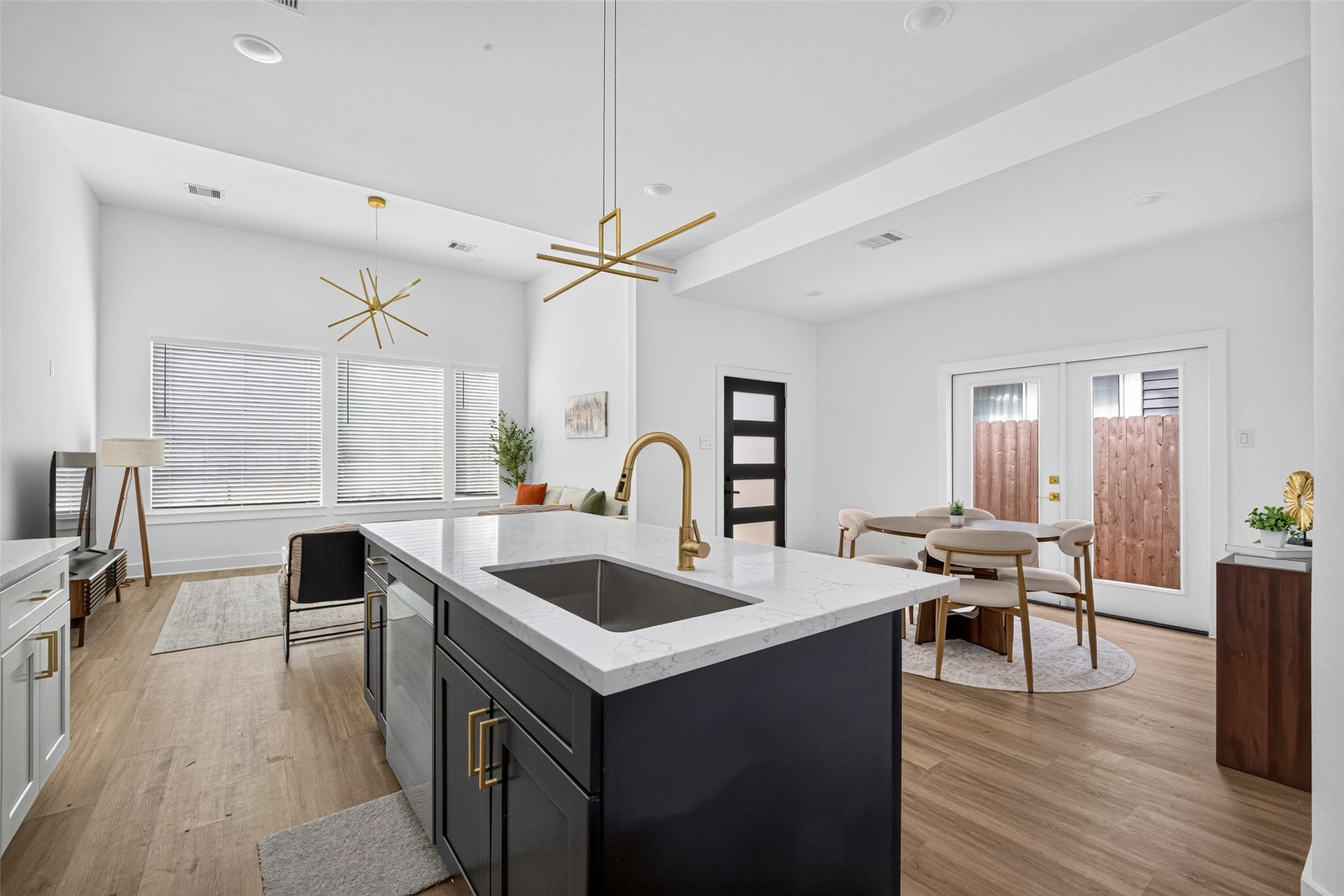 9309 Caddo Road, #B, Houston, TX 77078 The high-end center island takes center stage with its elegant white quartz waterfall counters and a striking gold gooseneck faucetoffering a picture-perfect setting for prep work, casual dining, or entertaining.