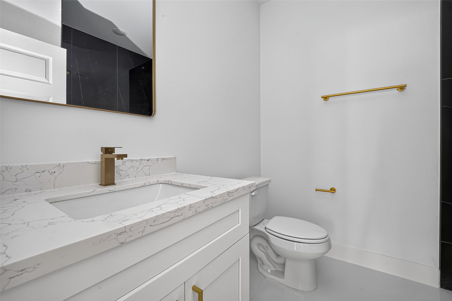 9309 Caddo Road, #B, Houston, TX 77078 Designed with a spa-like feel, featuring crisp quartz countertops, a framed mirror, and rich gold fixtures that elevate your daily routine.