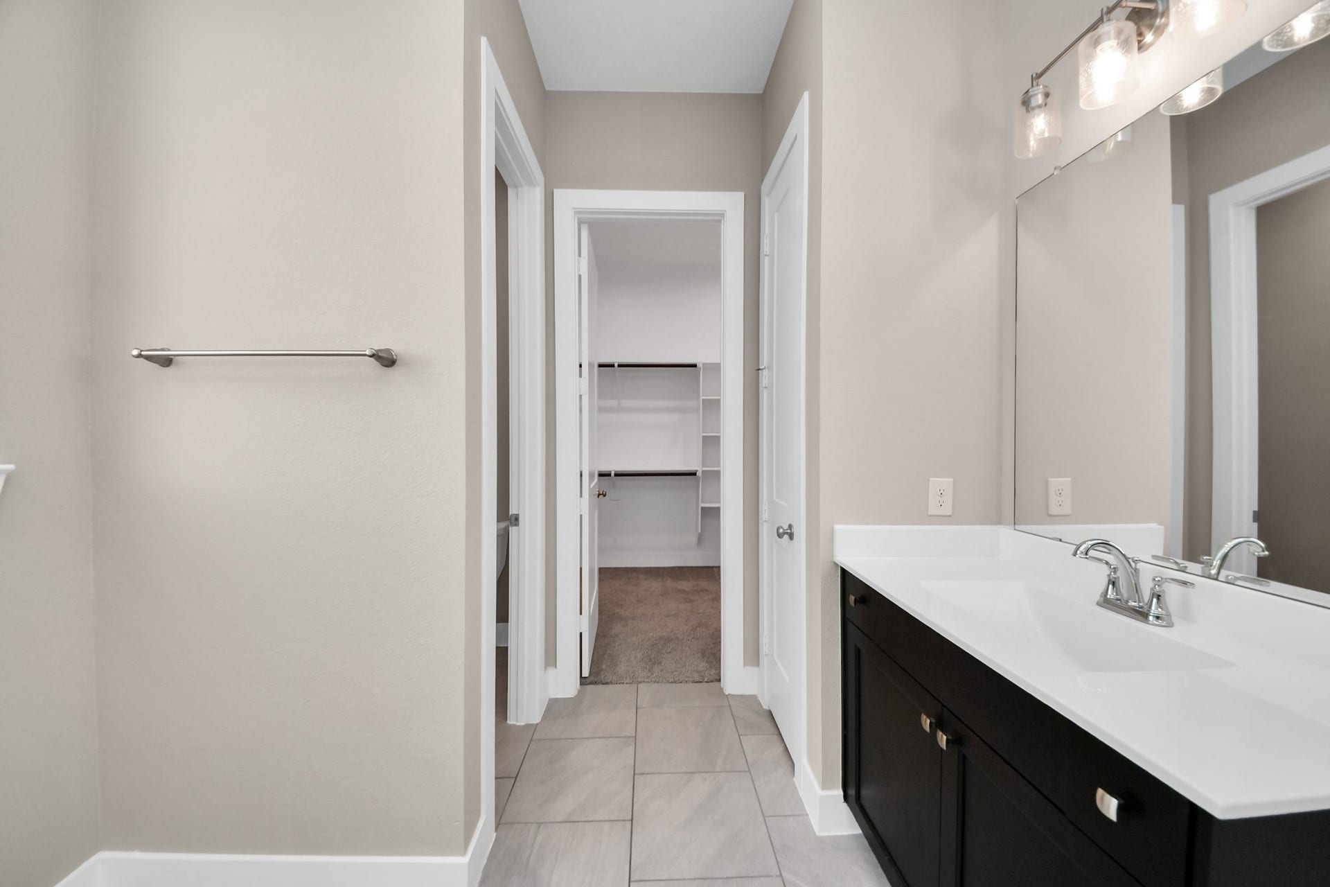 Primary bathroom sink and walk in closet