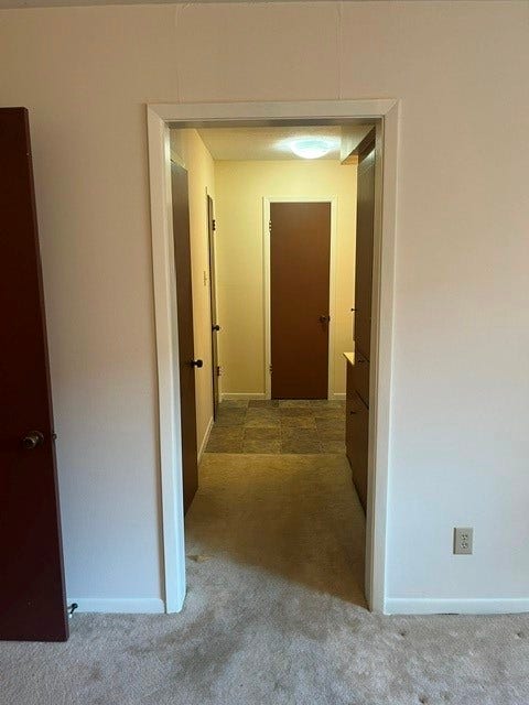 Hallway off of entrance leading to bedrooms.