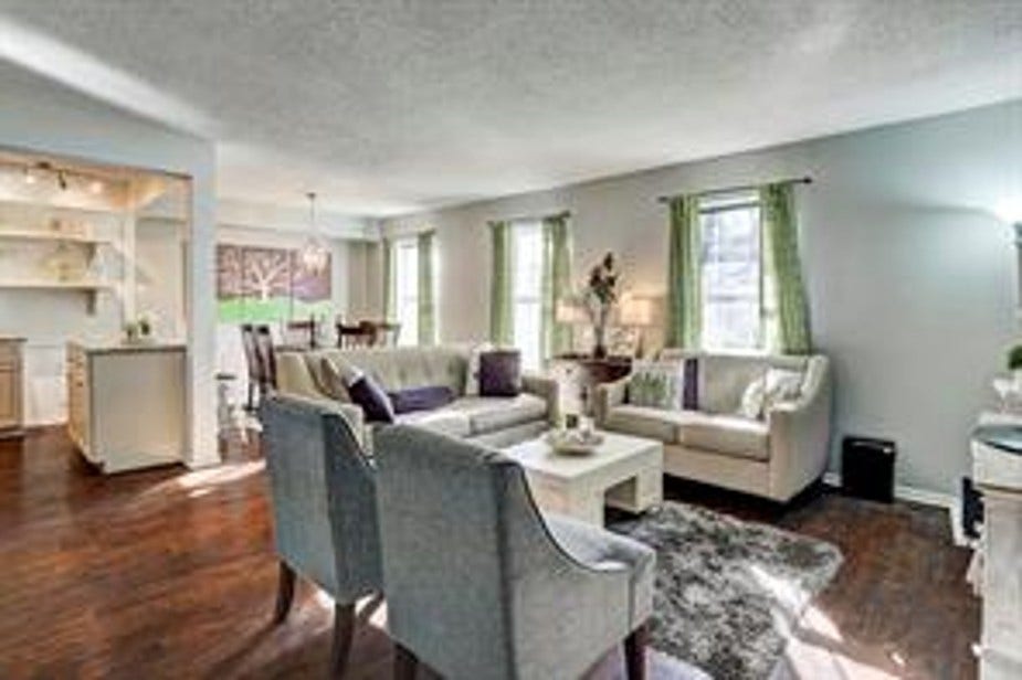 The room flows seamlessly into a dining area and kitchen, creating a perfect setting for entertaining.
