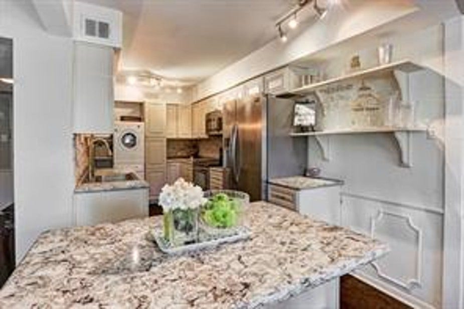 More space than you would expect in a condo! The lighting enhances its bright and welcoming atmosphere. Bright white painted walls give a modern, clean look.