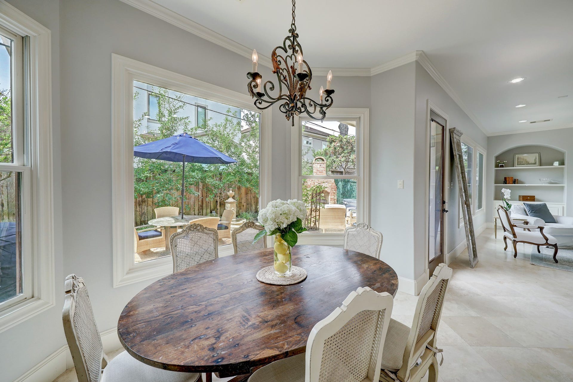 6004 Lake Street, Houston, TX 77005 Bright breakfast room with large windows offering views to a charming outdoor patio.