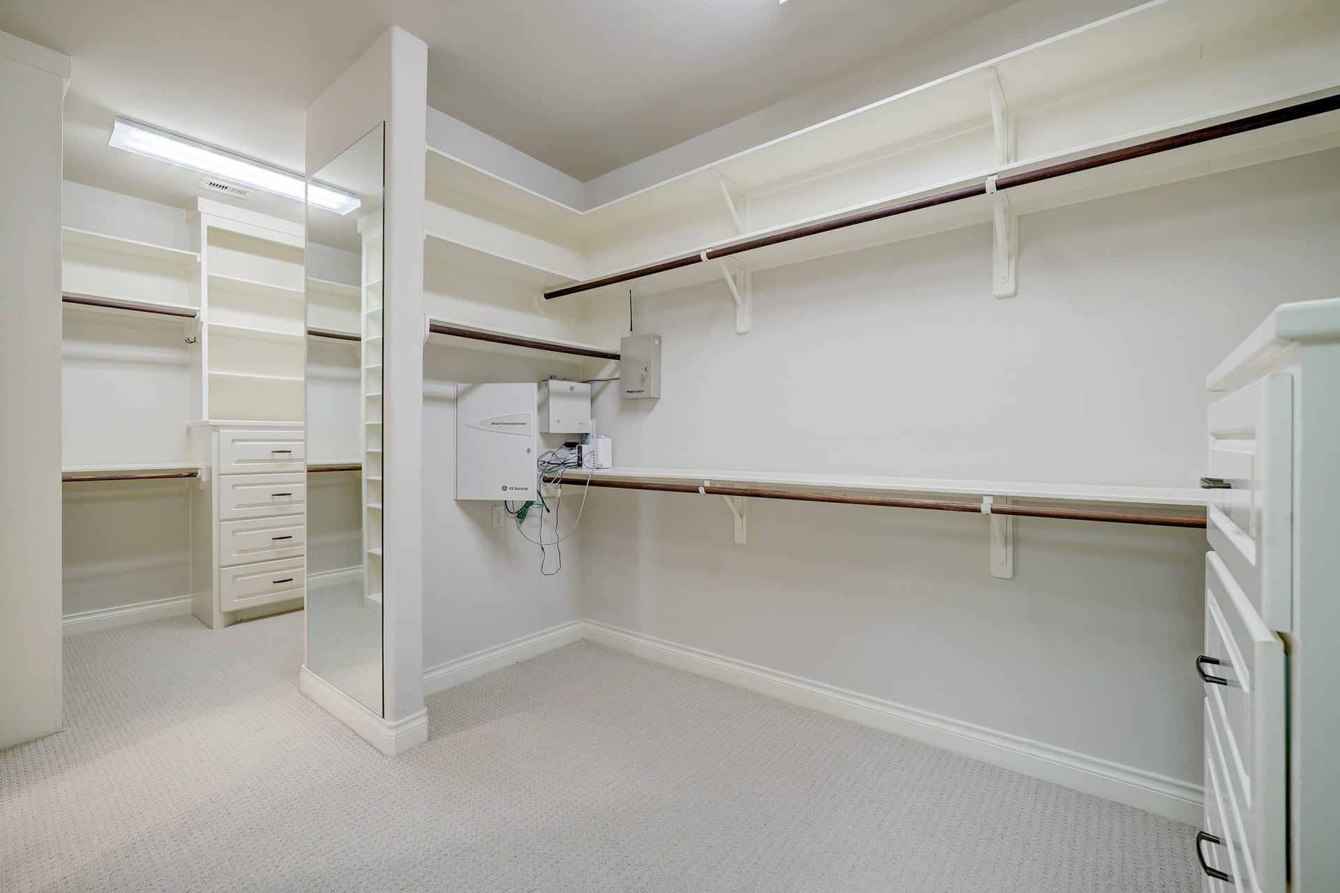 6004 Lake Street, Houston, TX 77005 Spacious walk-in closet for the primary bedroom featuring ample shelving, hanging space, and built-in drawers for organized storage.