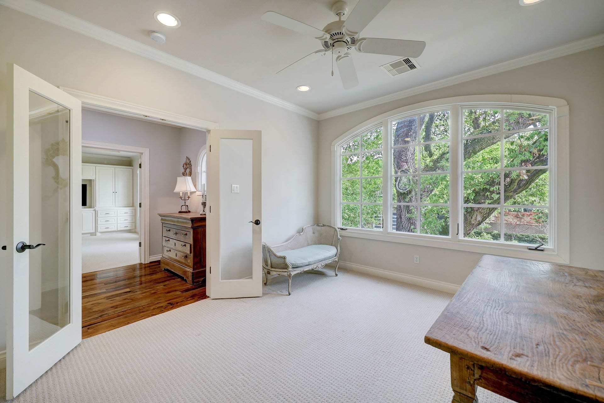 6004 Lake Street, Houston, TX 77005 Secondary bedroom at the front of the house featuring a large arched window with tree views