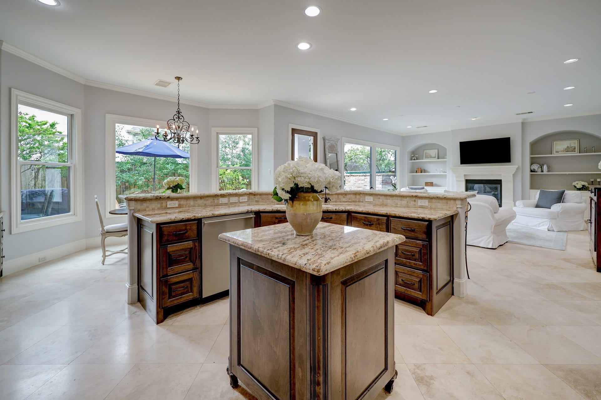 6004 Lake Street, Houston, TX 77005 Fabulous kitchen with spacious countertops, rich wood cabinetry, and an open layout leading to family room with a fireplace and ample natural light.