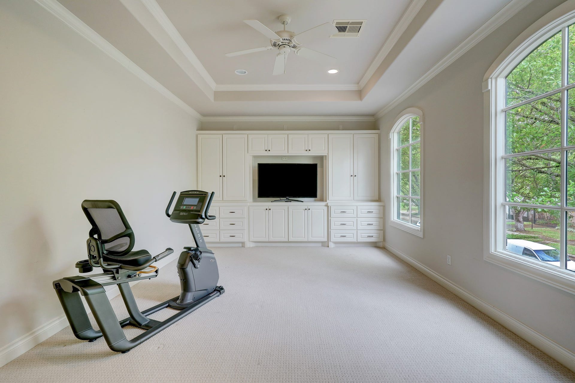 6004 Lake Street, Houston, TX 77005 Bright and spacious game room or 5th bedroom featuring large windows for natural light, and custom built-in cabinetry with a media center.