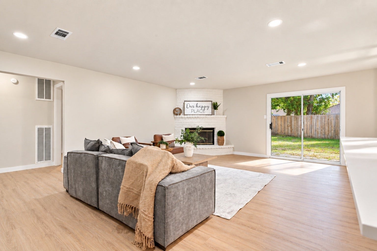 This living room leads out into the backyard through a sliding door.