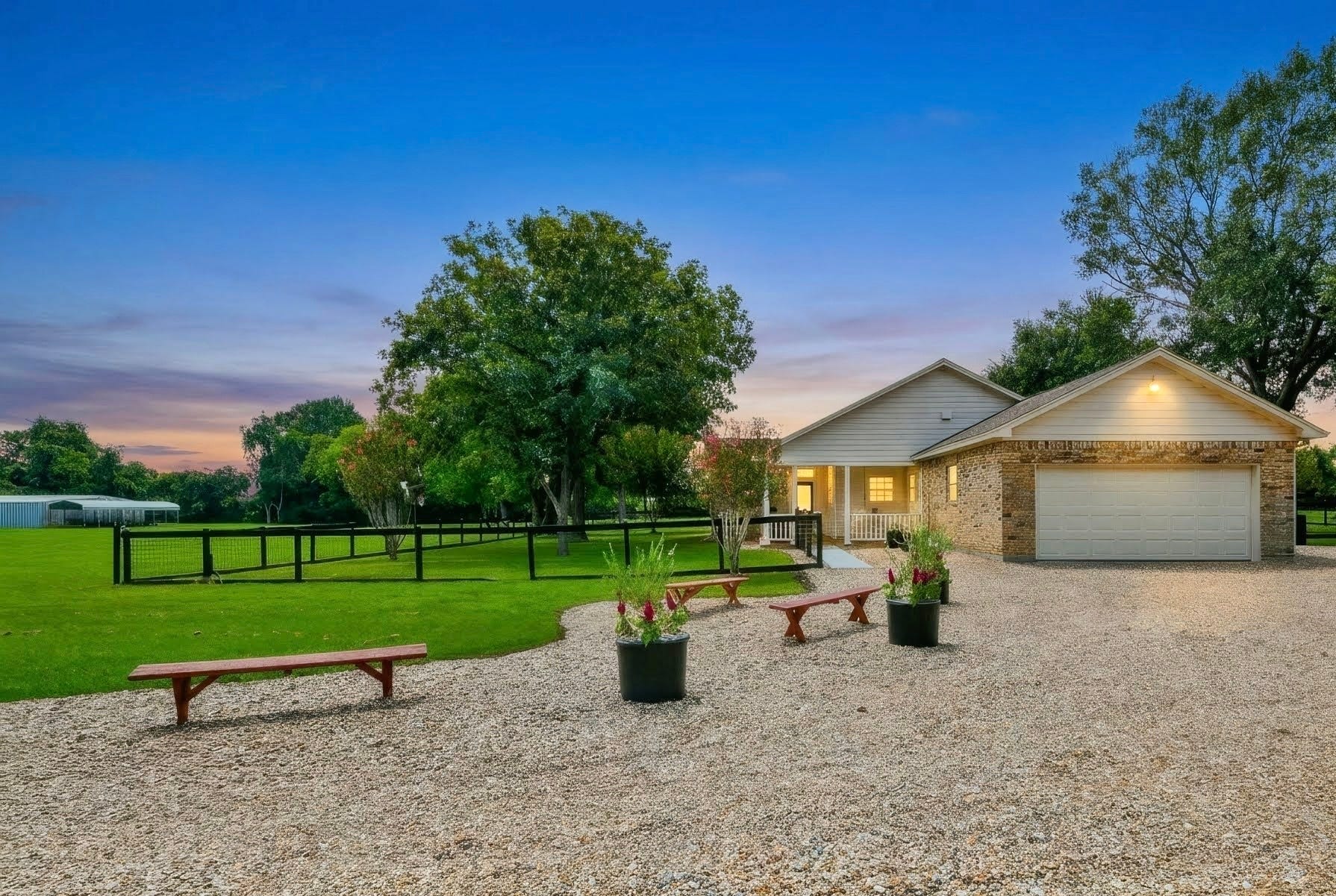 22035 Buescher Road, Tomball, TX 77377 New gravel driveway, primary house with huge porch, and a view of the building towards the front of the property