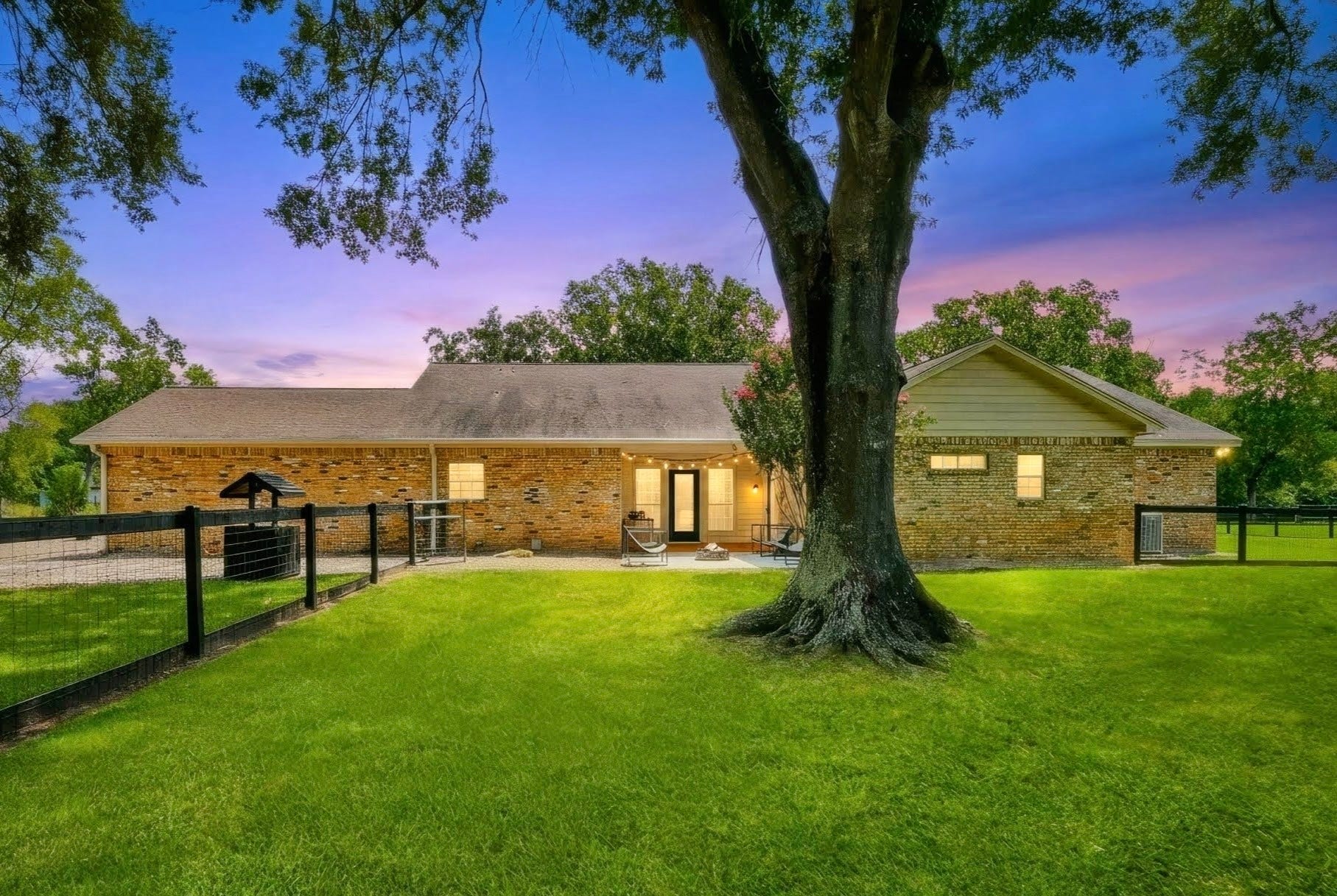 22035 Buescher Road, Tomball, TX 77377 View of the primary house from the backyard featuring the covered rear porch and bricked firepit area