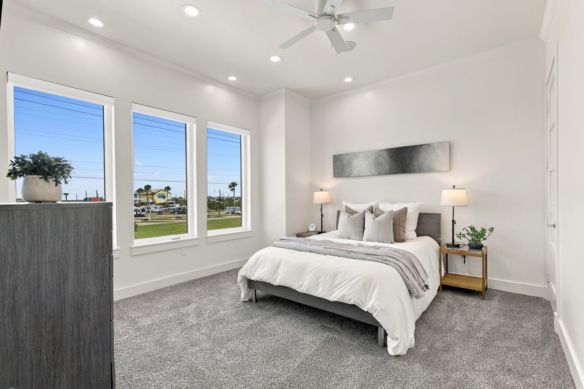 17211 Termini San Luis Pass Rd, Galveston, TX 77554 Secondary bedroom
Sun-filled secondary bedroom with three tall windows, soft carpeting, and a neutral palette. Recessed lighting and a ceiling fan complete this comfortable retreat.