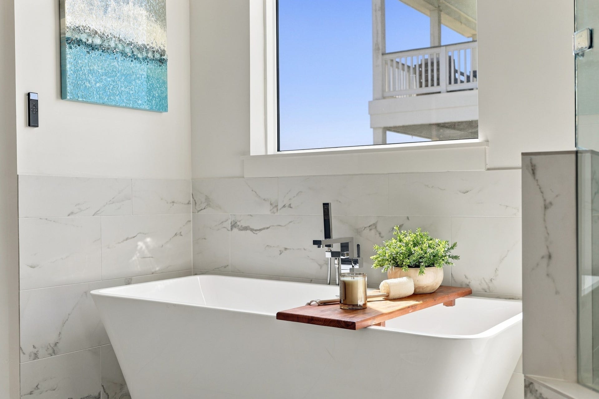 17211 Termini San Luis Pass Rd, Galveston, TX 77554 Freestanding soaking tub
Unwind in the freestanding soaking tub, complemented by a floor-mounted chrome faucet and elegant marble-look tile. Natural light enhances the bathrooms calm, airy atmosphere.