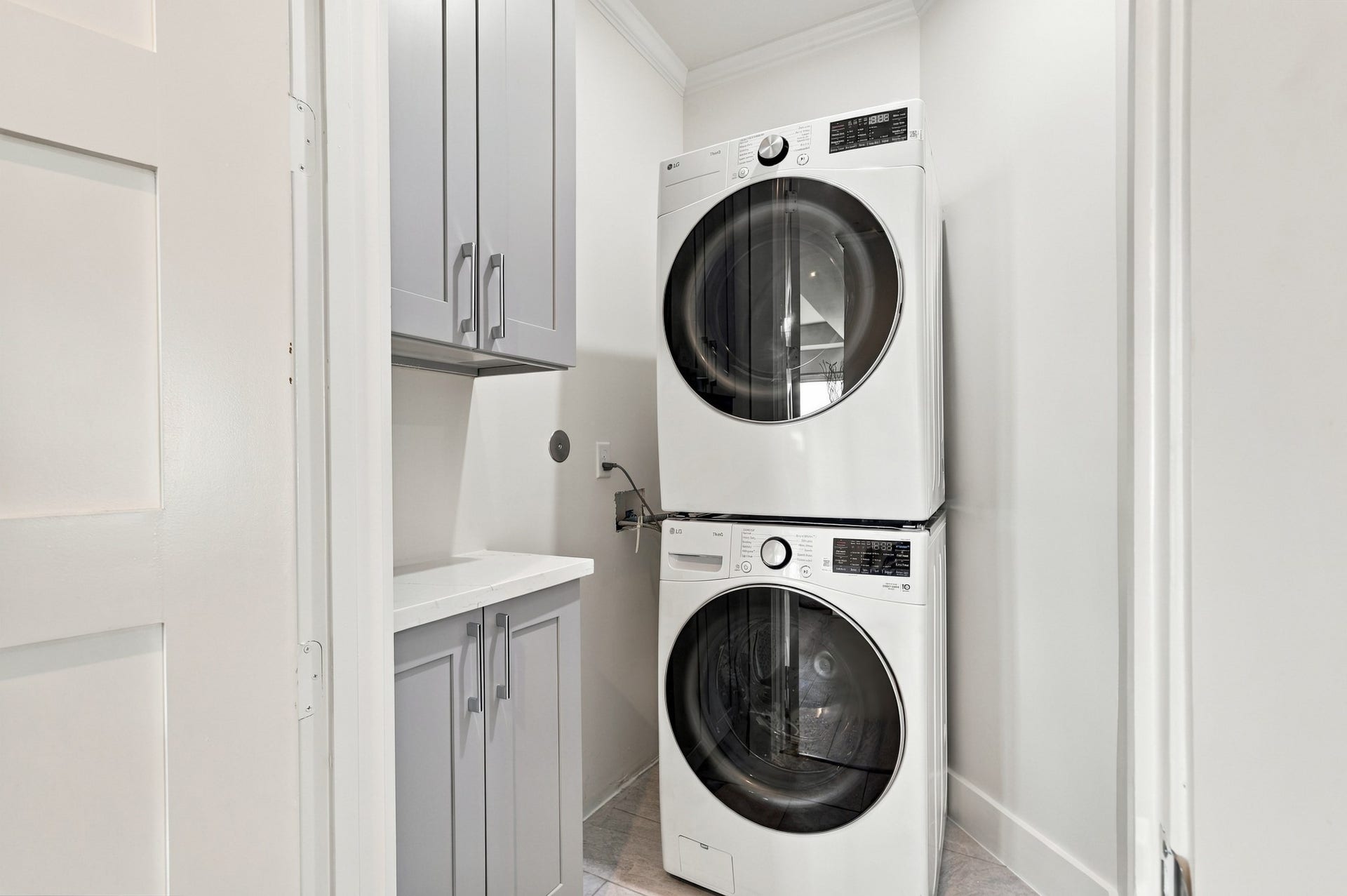 17211 Termini San Luis Pass Rd, Galveston, TX 77554 Additional laundry area
A second laundry area offers added convenience with stacked appliances, a compact counter, and upper and lower cabinetry. The efficient layout keeps everyday essentials neatly organized.