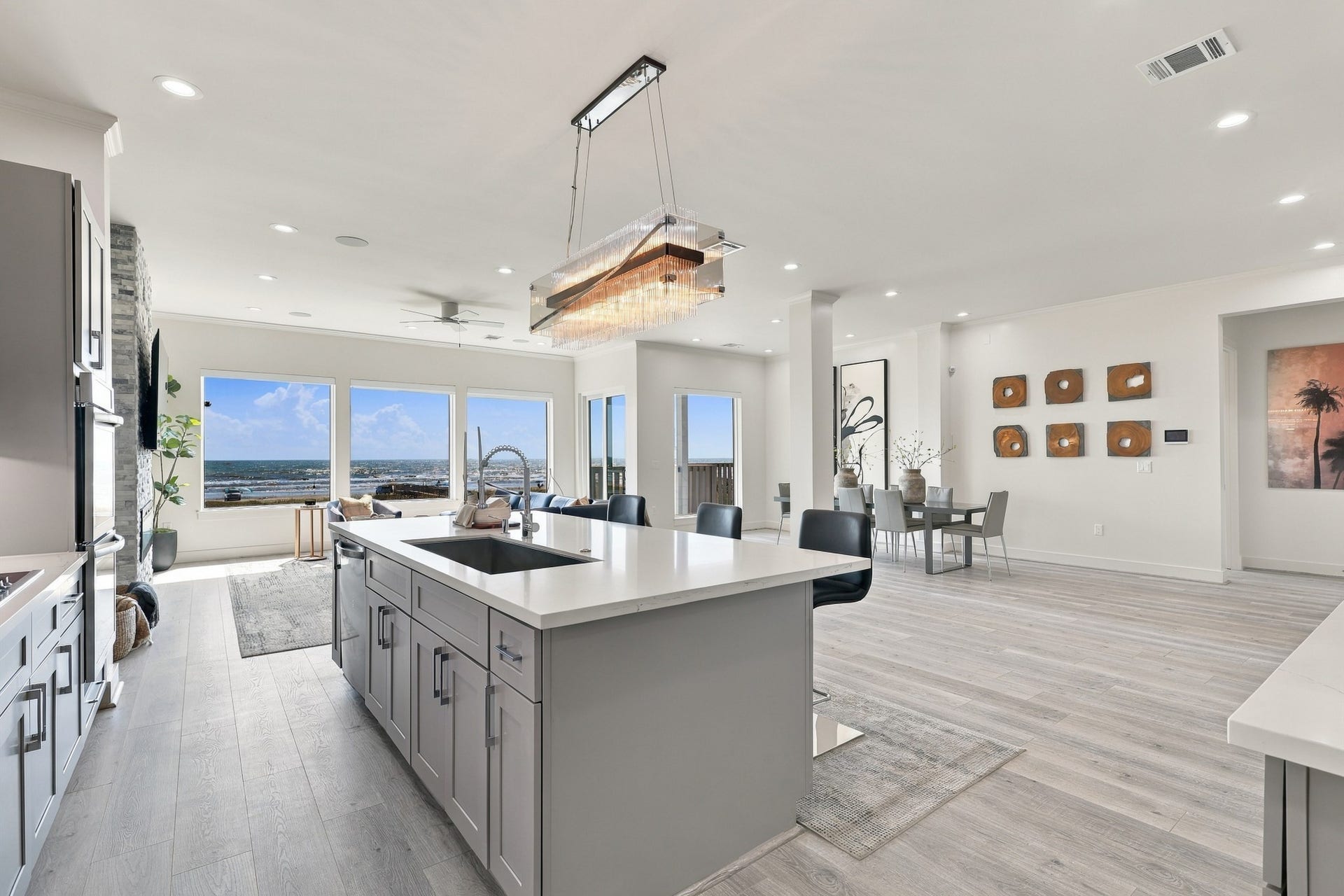 17211 Termini San Luis Pass Rd, Galveston, TX 77554 The generous kitchen island offers ample preparation space and casual seating, with views extending through the living area to the Gulf beyond.