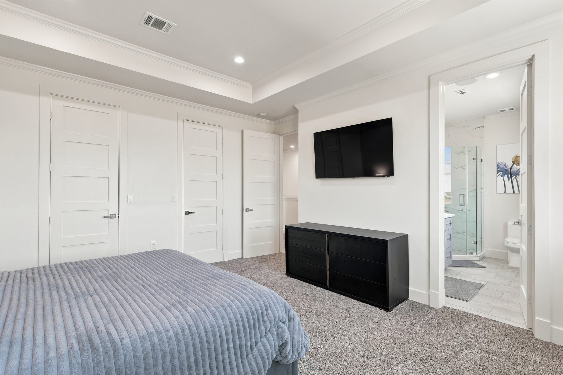 17211 Termini San Luis Pass Rd, Galveston, TX 77554 Bedroom with adjoining bathroom
An alternate view showcases the bedrooms paneled doors, architectural ceiling detail, and direct access to an adjoining bathroom. A comfortable layout provides room for both sleeping and storage furnishings.