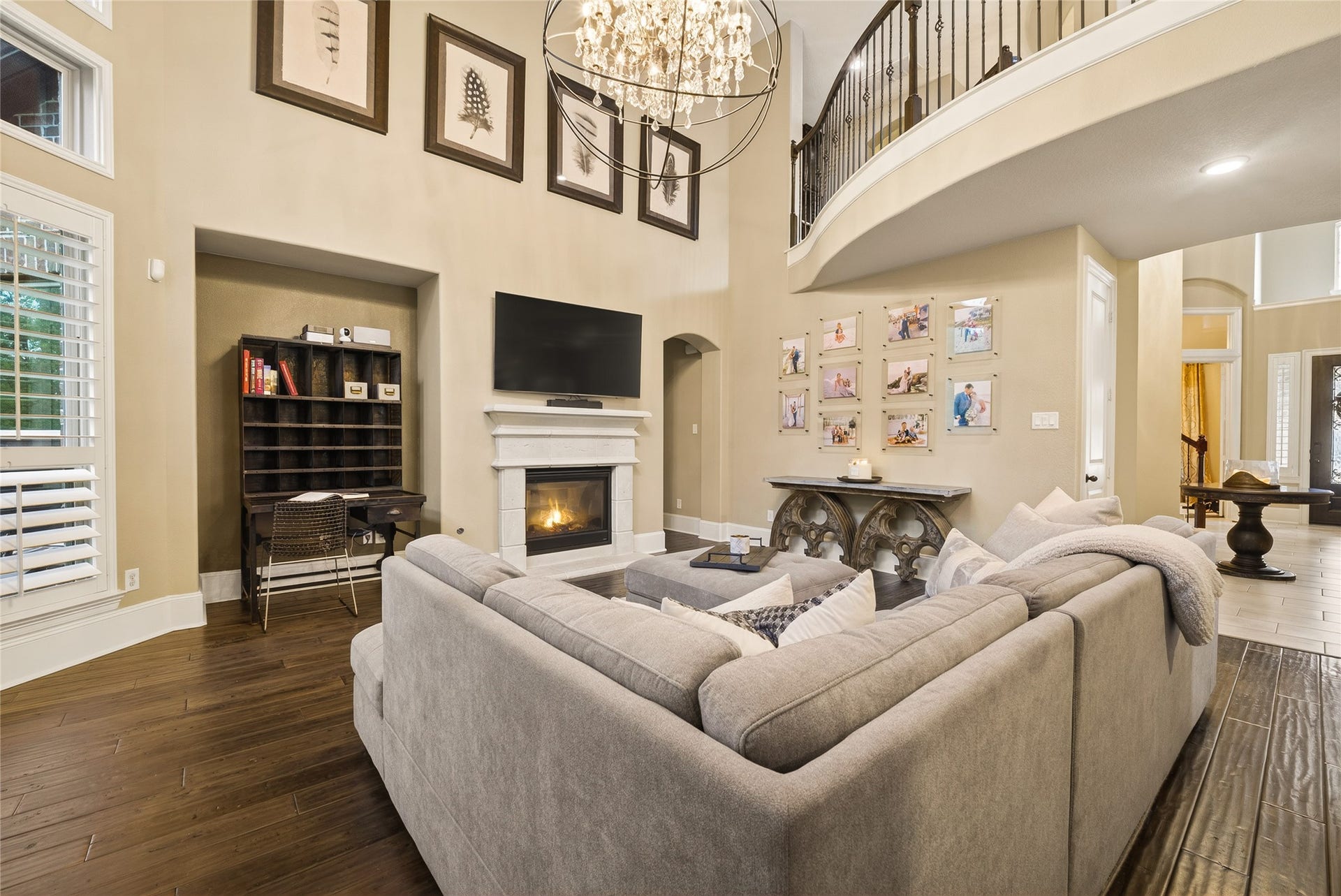 7907 Augusta Creek Court, Spring, TX 77389 Enjoy family time snuggled up in front of this fireplace. Elegant hardwood floors, natural from all the large windows with shutters, and a grand chandelier adds a touch of luxury.