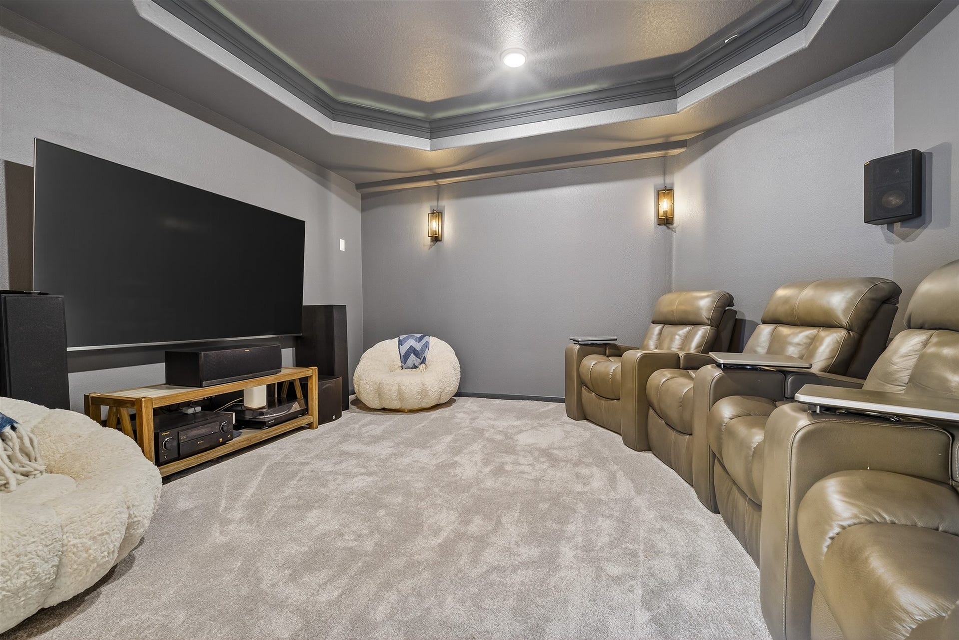 7907 Augusta Creek Court, Spring, TX 77389 Tray ceilings, stylish wall sconces, and warm color tones really set the stage for movie night.
