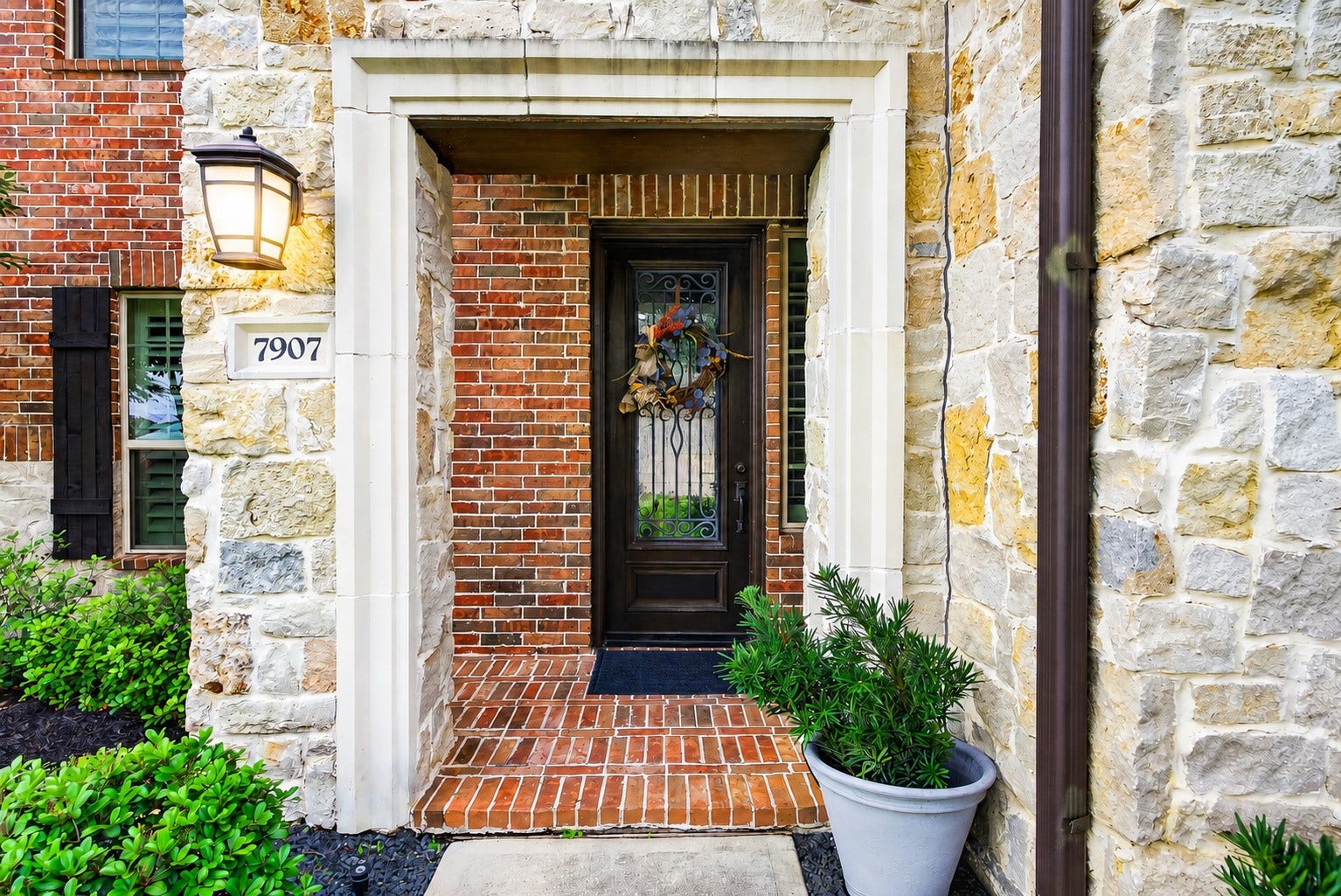 7907 Augusta Creek Court, Spring, TX 77389 What a welcoming covered front entryway with a charming brick and stone facade.