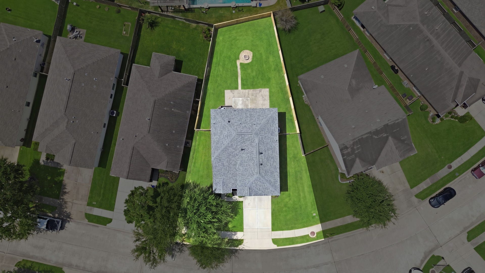 15435 Kaston Drive, Cypress, TX 77433 Aerial view reveals the deep lot shape, highlighting the sprawling backyard space with its central fire pit and patio setup.