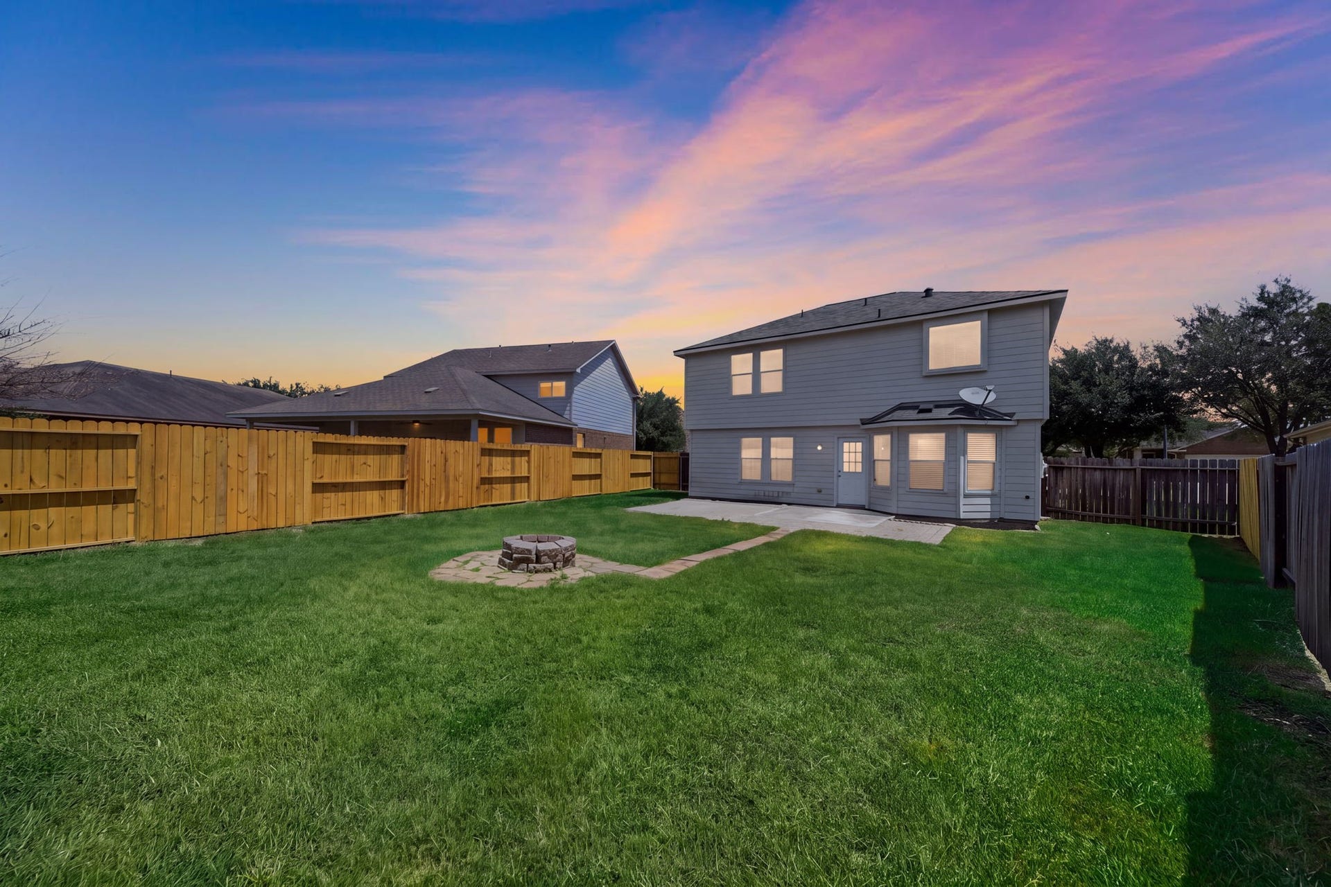 15435 Kaston Drive, Cypress, TX 77433 A stone fire pit with a flagstone path serves as the focal point in this fully fenced, expansive green backyard featuring a concrete patio.
