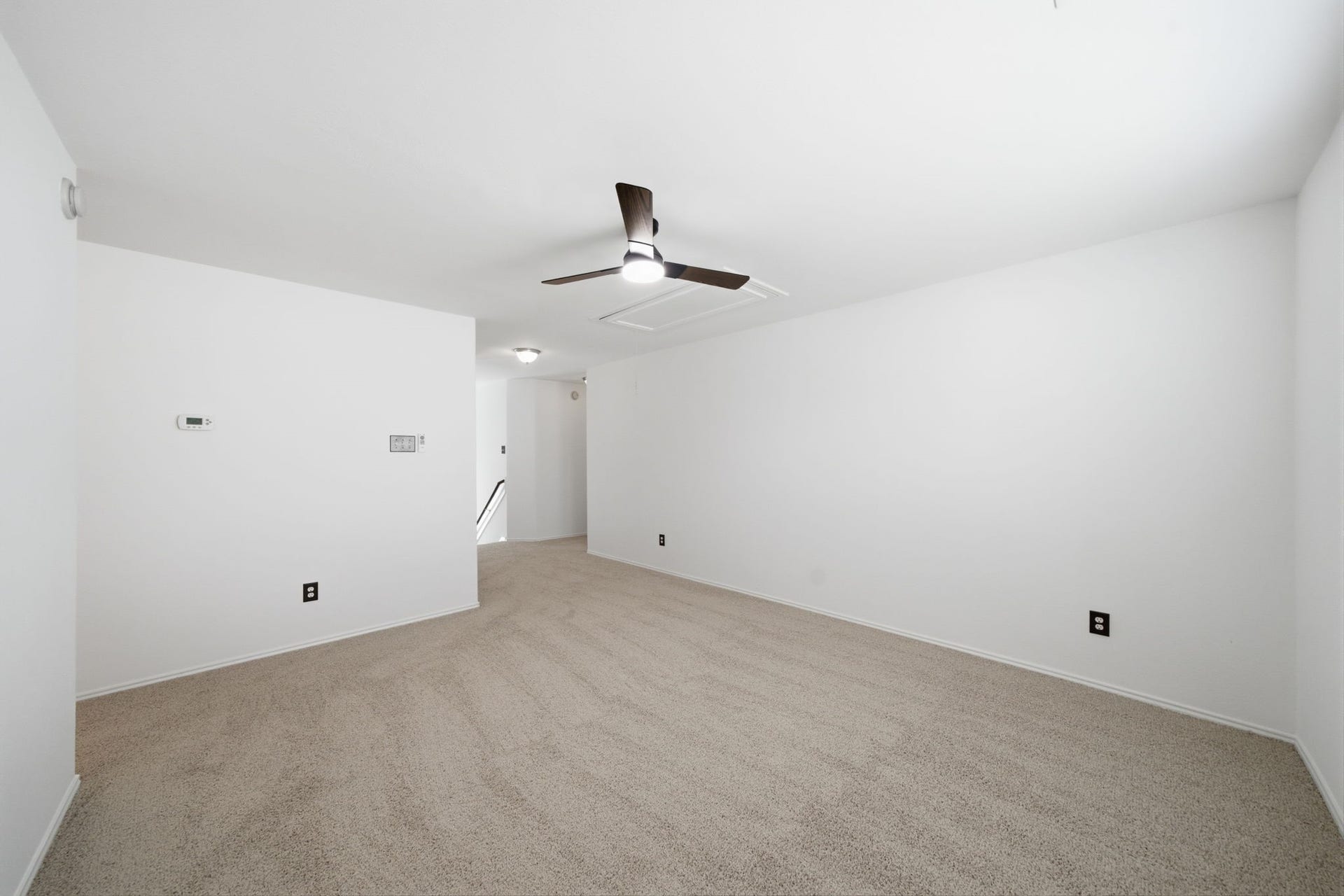 15435 Kaston Drive, Cypress, TX 77433 Soft carpet flooring and fresh neutral paint frame this flexible second-floor gameroom with a central ceiling fan. An open layout connects directly to the hallway, offering a versatile space for recreation or lounging.