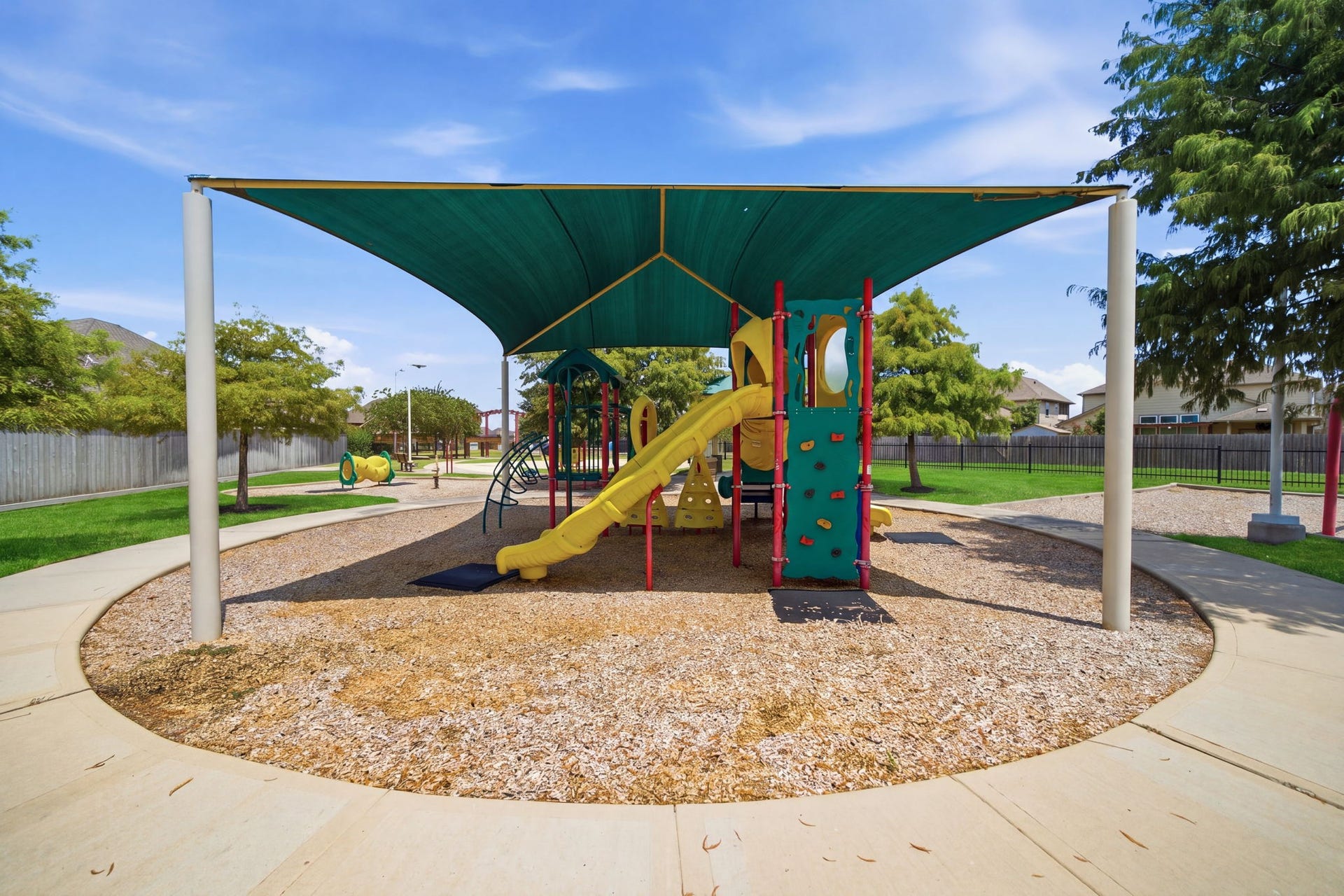 15435 Kaston Drive, Cypress, TX 77433 A shade canopy covers this neighborhood playground featuring a slide, climbing wall, and surrounding walking path.