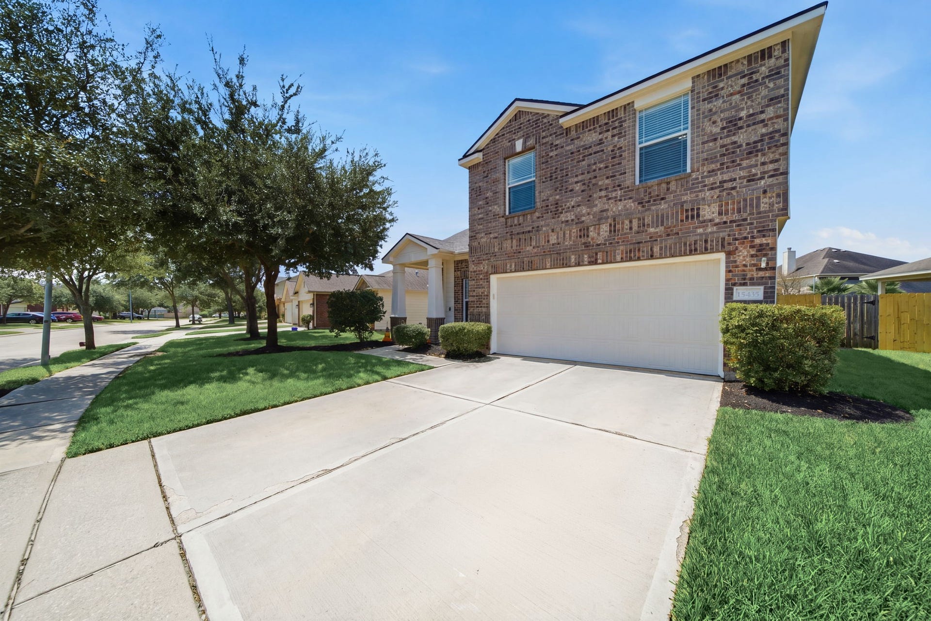 15435 Kaston Drive, Cypress, TX 77433 An expansive double-wide driveway leads to the 2-car garage and attached brick facade of this two-story home.