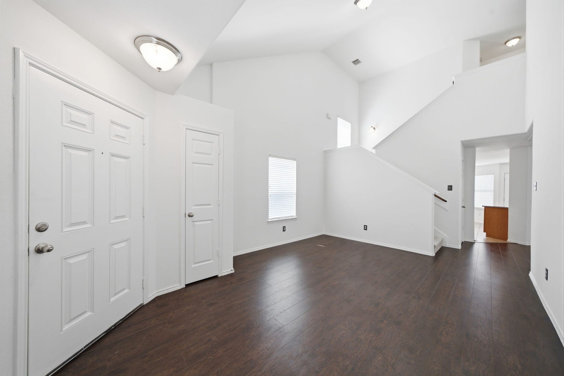 15435 Kaston Drive, Cypress, TX 77433 Soaring vaulted ceilings and rich wood-look flooring extend throughout this versatile formal dining space. Positioned steps from the entryway, the generous layout connects seamlessly toward the main living area and kitchen.