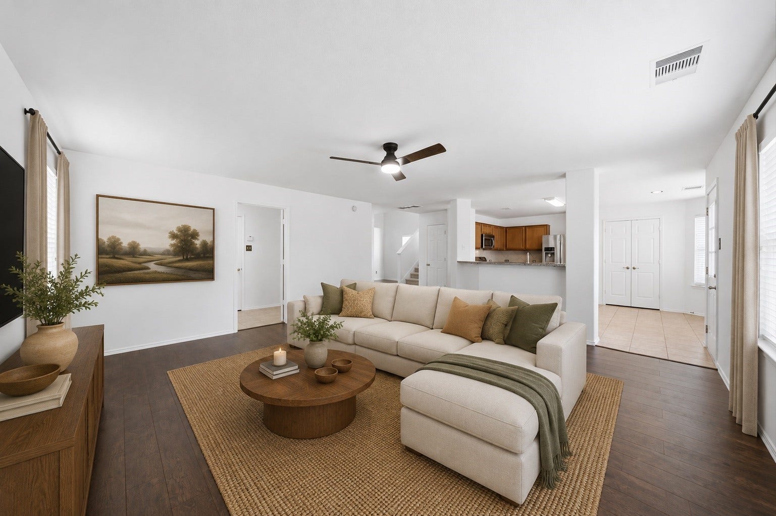 15435 Kaston Drive, Cypress, TX 77433 Rich hardwood floors and a modern ceiling fan anchor this spacious first-floor living room with an open layout. Seamless sightlines lead straight past the raised breakfast bar into the adjacent kitchen, creating an effortless flow.