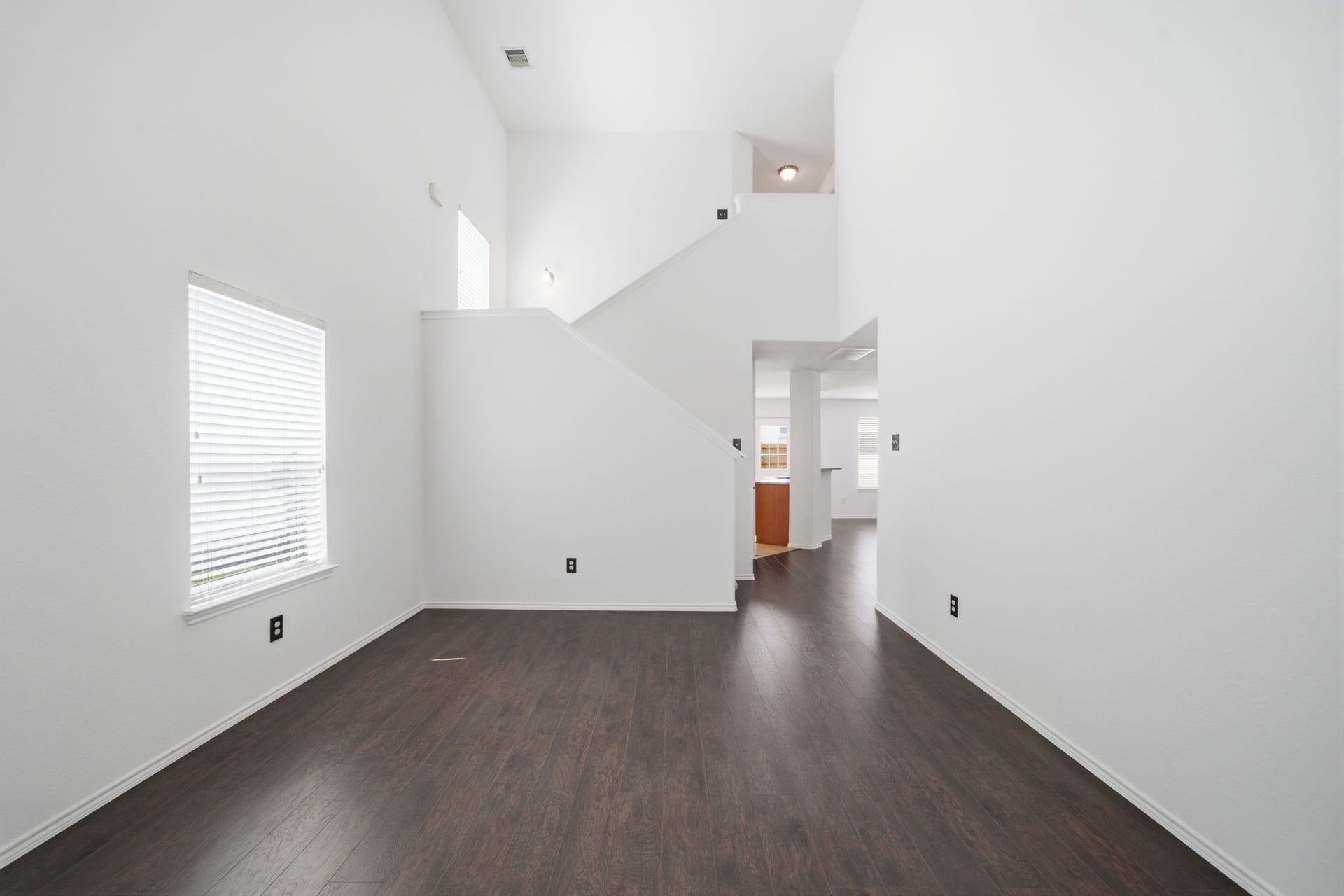 15435 Kaston Drive, Cypress, TX 77433 Soaring two-story ceilings and rich wood-look flooring enhance the open design of this flexible formal dining room. Convenient proximity to the kitchen makes hosting and entertaining seamless.