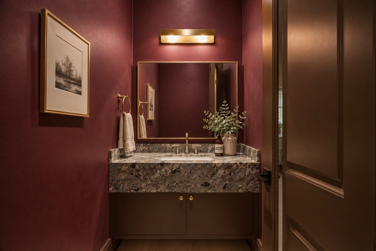 316 W 30th Street, Houston, TX 77018 Rich lime washed walls create a dramatic backdrop for this designer powder bath, complemented by a floating vanity with a unique red quartzite countertop, an integrated sink, and warm brass fixtures. A bold, elevated space that leaves a lasting impression for guests.