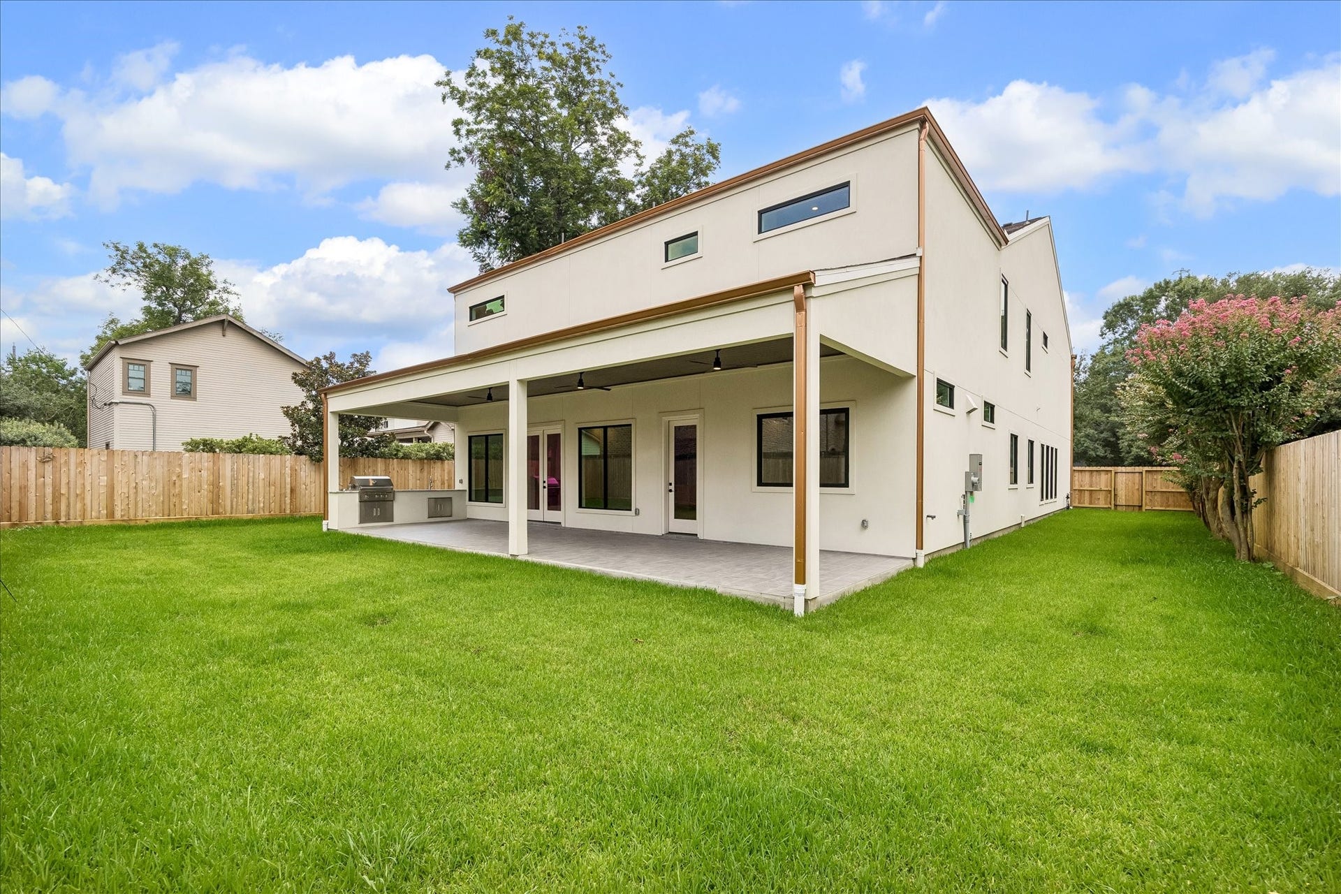 316 W 30th Street, Houston, TX 77018 Wide open green space pairs with a covered outdoor living area and built in kitchen for weekend cookouts and everyday enjoyment. The site plan allows room for a future pergola with fireplace and pool bath alongside a 25x14 pool (upgrade option, ~$70,000), plus an 18' x 100' side yard for turf or added green space. A full drainage system with a commercial grade, square gutter upgrade keeps the yard as functional as it looks.