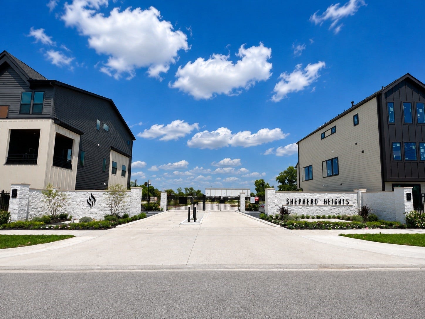 509 Hillwood Heights Drive, Houston, TX 77091 Modern gated community entrance at Shepherd Heights, featuring sleek architectural designs and well-manicured landscaping.