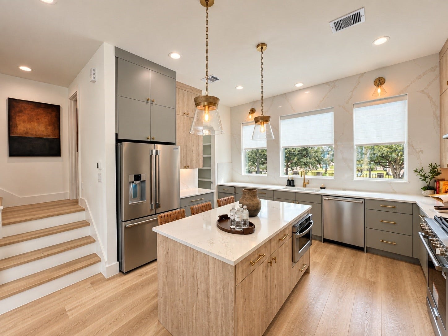 509 Hillwood Heights Drive, Houston, TX 77091 Sleek modern kitchen featuring a spacious island with elegant pendant lighting, stainless steel appliances, and ample natural light from large windows.