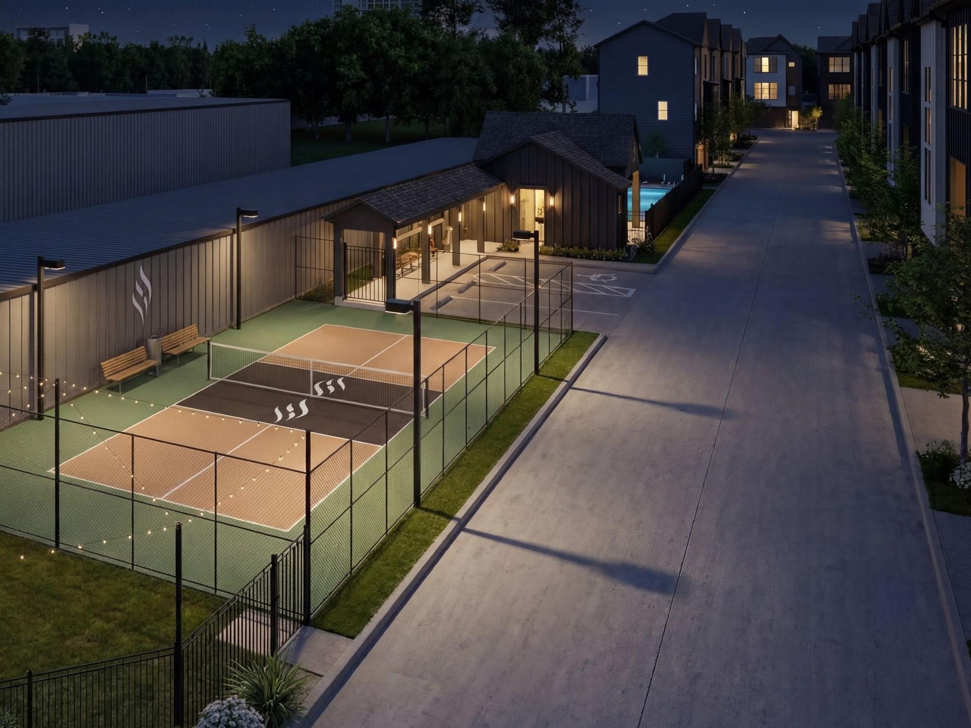 509 Hillwood Heights Drive, Houston, TX 77091 Enjoy a vibrant community lifestyle with illuminated tennis courts, inviting pathways, and modern amenities, perfect for evening leisure activities.