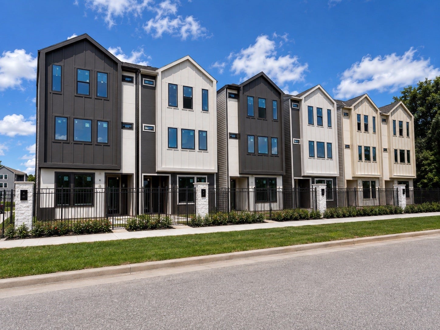 509 Hillwood Heights Drive, Houston, TX 77091 Modern townhomes with sleek, contemporary design and large windows, set behind a stylish fence and well-maintained landscaping.