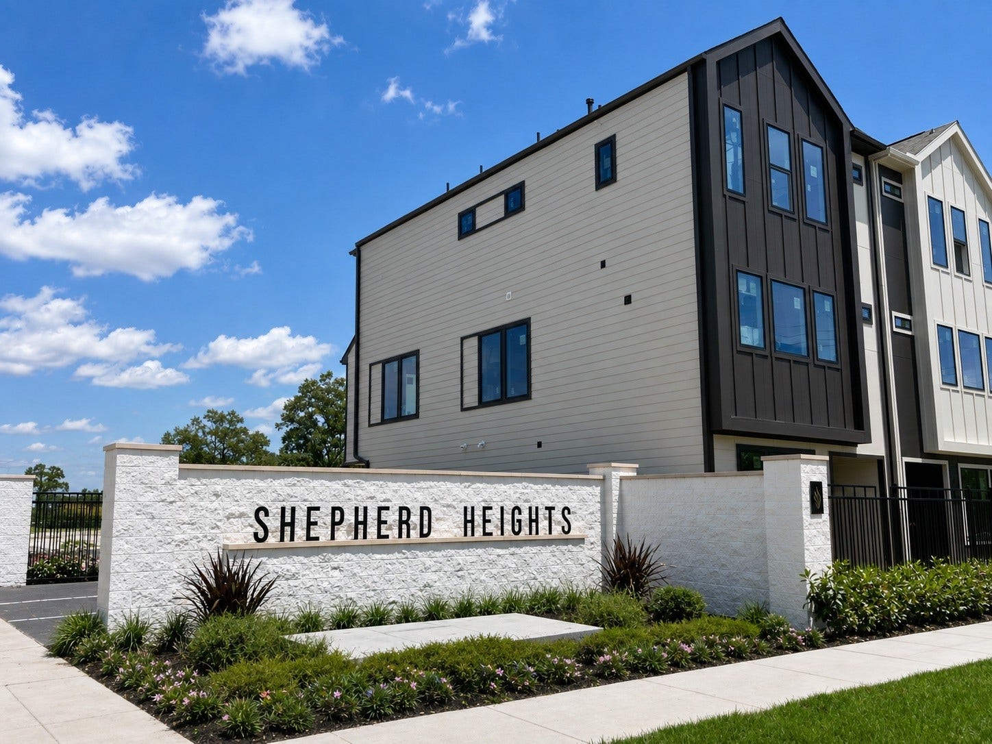 509 Hillwood Heights Drive, Houston, TX 77091 Modern townhouse in Shepherd Heights, featuring sleek architecture and expansive windows, set against a beautiful blue sky.