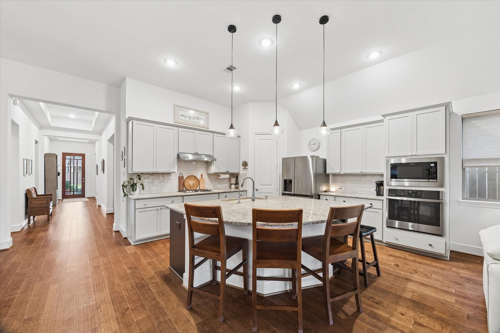 The oversized island and chef's kitchen are open to the living and dining rooms