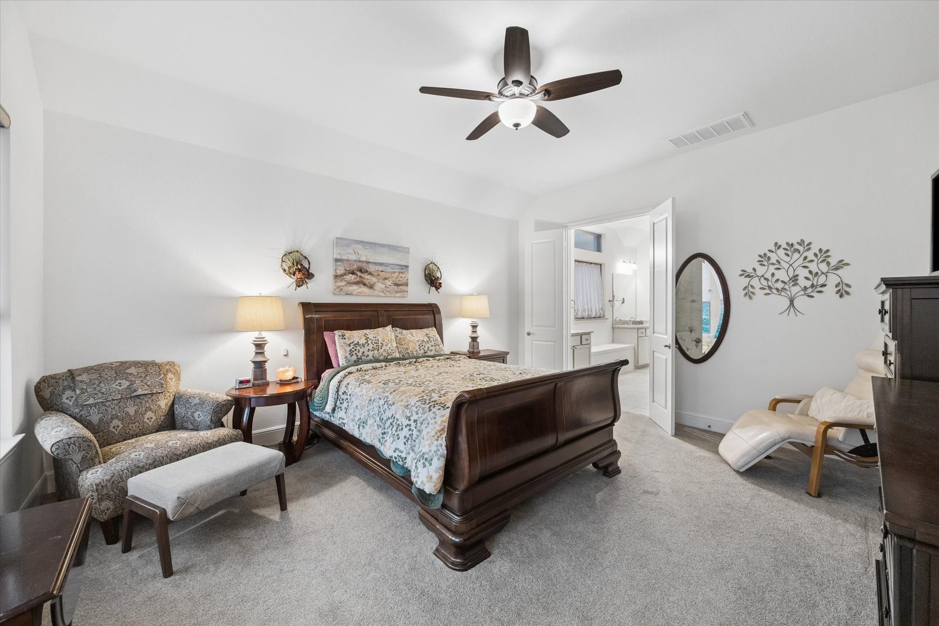 The beautiful primary suite feels like a retreat that you never want to leave. Motorized shades not shown.