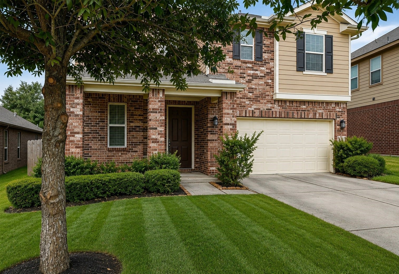 1972 Elkington Circle, Conroe, TX 77304 Charming brick home features a spacious front yard and an inviting covered front porch - front door freshly refinished!
