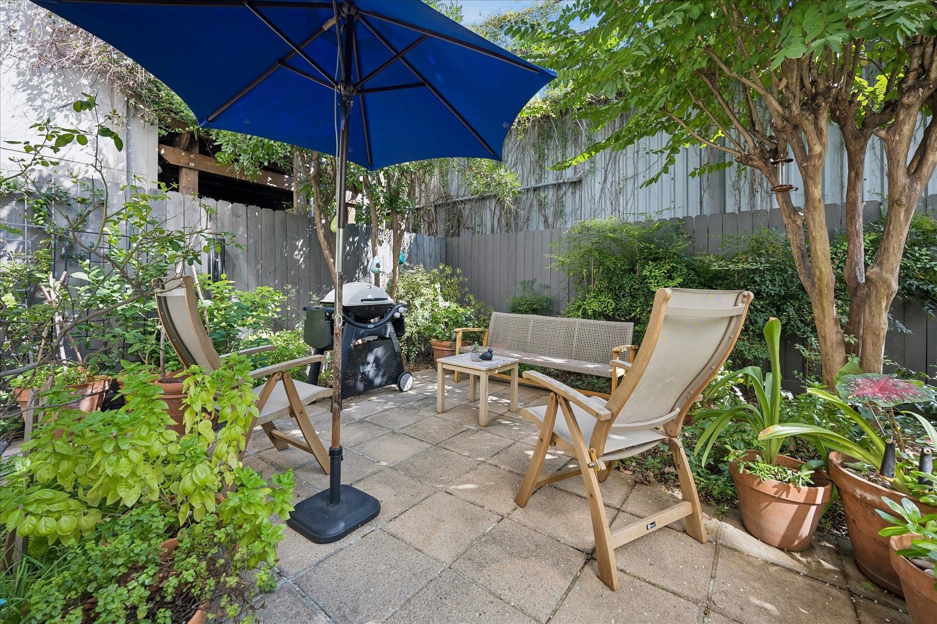 This private BACK PATIO with lush landscaping is a wonderful place to dine al fresco or enjoy your morning coffee.