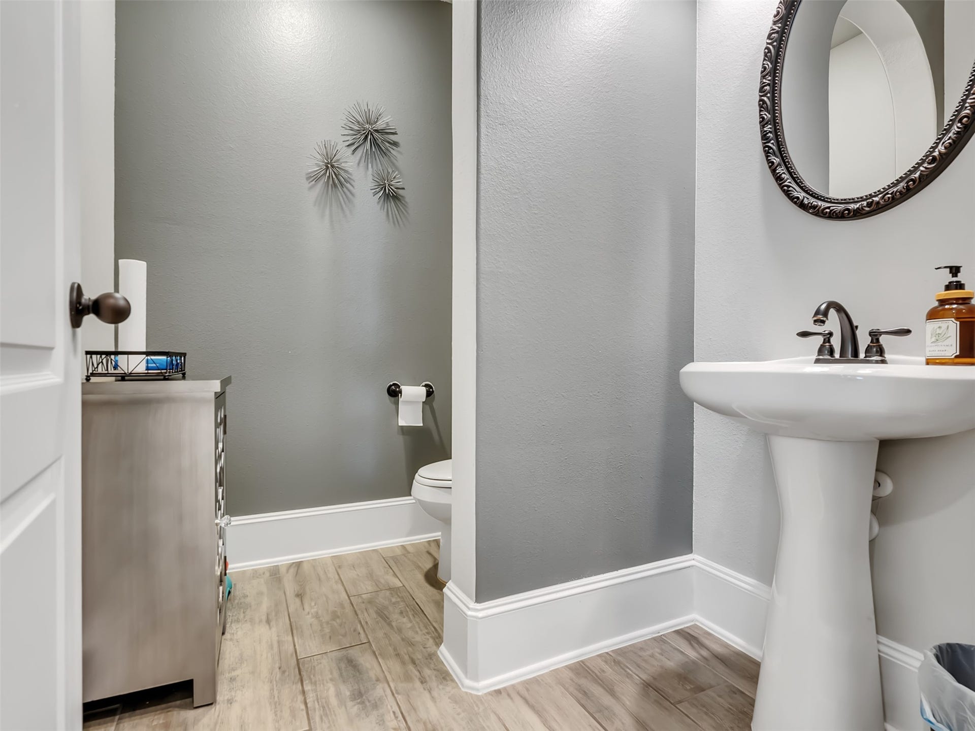 10302 Muir Peak Drive, Rosharon, TX 77583 Powder room with pedestal sink and neutral color tones with tile flooring.