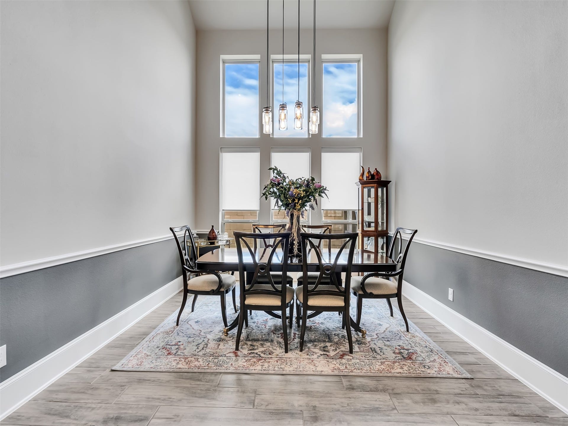 10302 Muir Peak Drive, Rosharon, TX 77583 Dining room area with large windows and chair rail moldings accent this rooms inviting atmosphere.