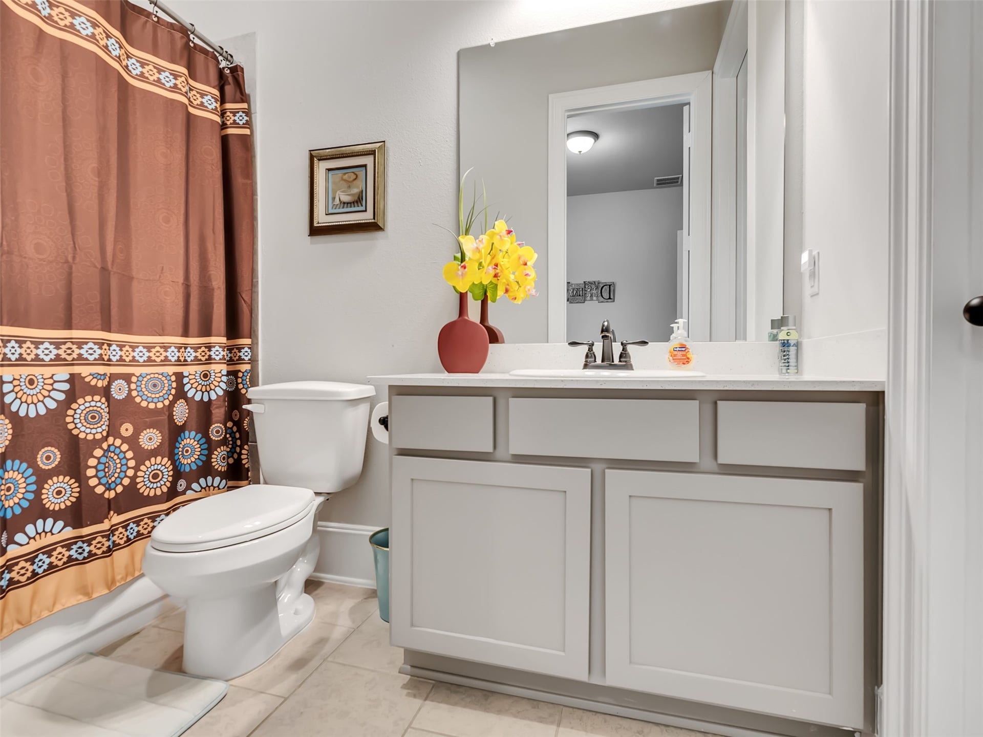 10302 Muir Peak Drive, Rosharon, TX 77583 Guest bathroom with modern vanity with white cabinetry.