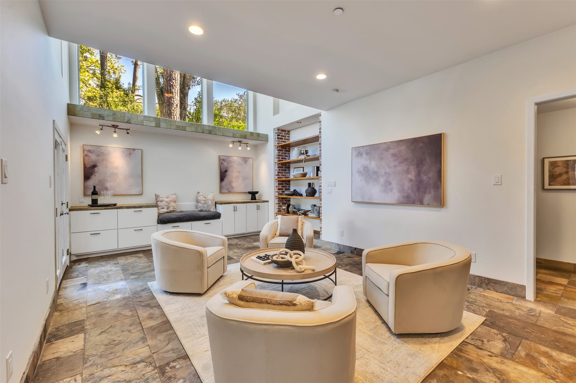 Positioned directly off the kitchen, this versatile flex room features soaring 20 ft ceilings and large windows, offering a bright, adaptable space for whatever your family needs.